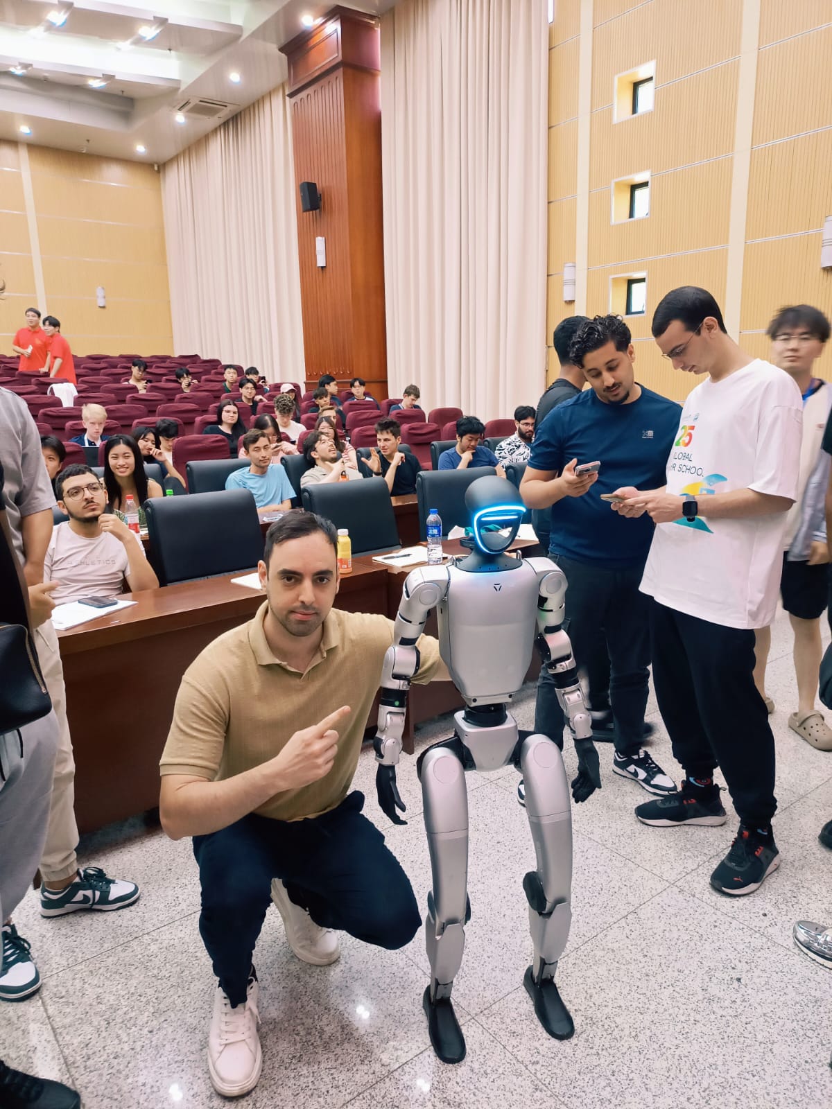 Oriol Martinez with a humanoid robot during an AI and robotics session at HUST
